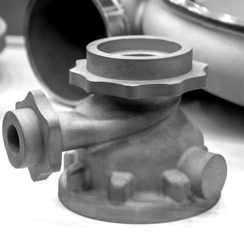 Fluid-carrying component (pipe connector) made of 3D-printed stainless steel.